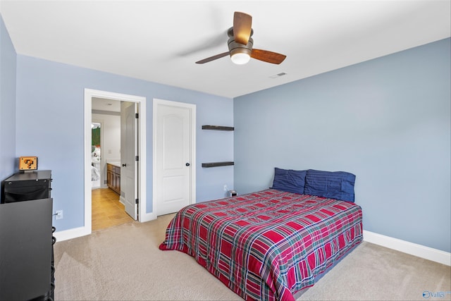 carpeted bedroom with connected bathroom and ceiling fan