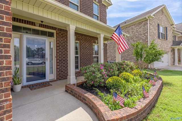 doorway to property with a garage and covered porch