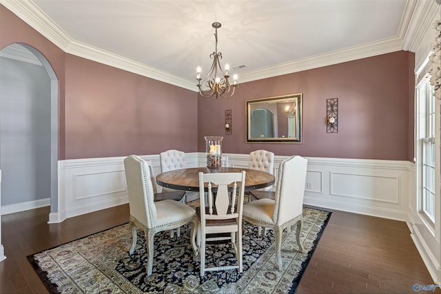 dining area with a notable chandelier, crown molding, and dark hardwood / wood-style floors