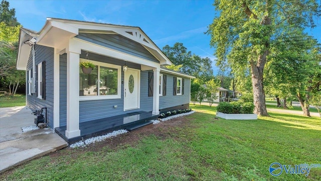 view of side of home with crawl space and a yard