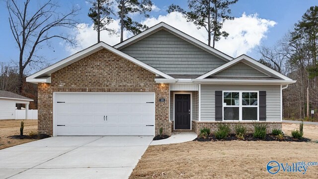 view of front of house featuring a front yard and a garage