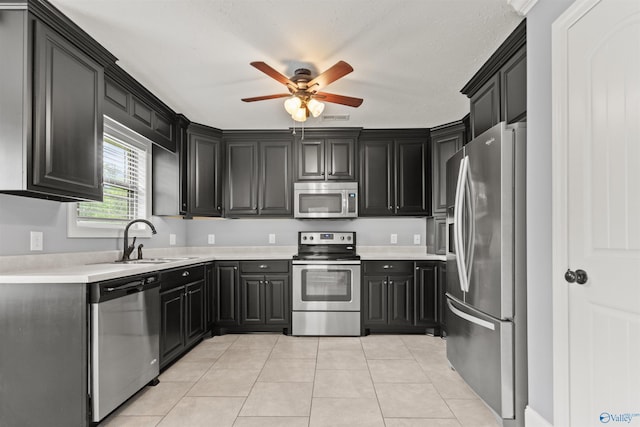 18226 Whitetail Ln, Athens, AL 35613 - kitchen with stainless steel appliances, a sink, a ceiling fan, light countertops, and light tile patterned flooring