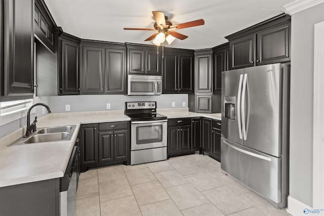 18226 Whitetail Ln, Athens, AL 35613 - kitchen with appliances with stainless steel finishes, a sink, a ceiling fan, light tile patterned floors, and light countertops