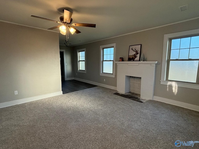 unfurnished living room with a fireplace with flush hearth, dark carpet, and crown molding