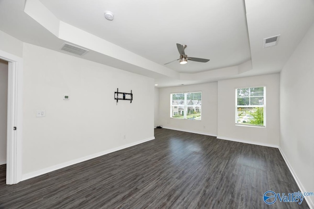 6032 Barringer Ct, Huntsville, AL 35806 - empty room featuring visible vents, baseboards, a raised ceiling, ceiling fan, and dark wood-type flooring