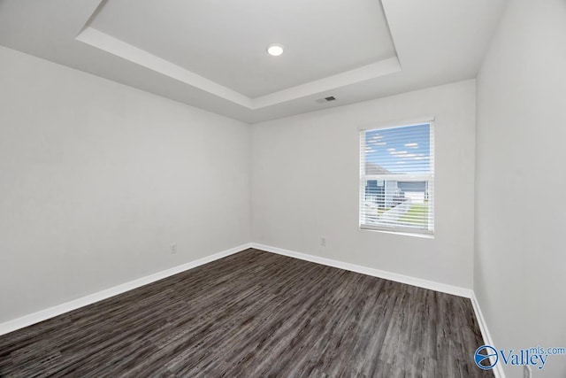 6032 Barringer Ct, Huntsville, AL 35806 - unfurnished room with a tray ceiling, baseboards, dark wood finished floors, and recessed lighting
