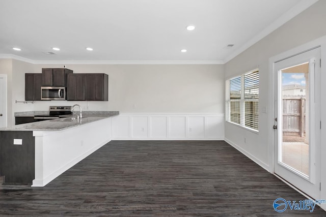 6032 Barringer Ct, Huntsville, AL 35806 - kitchen with crown molding, dark brown cabinetry, dark wood-style flooring, and stainless steel appliances
