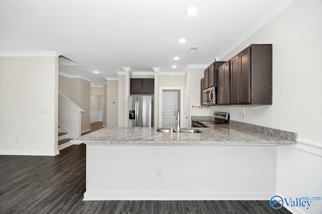 6032 Barringer Ct, Huntsville, AL 35806 - kitchen with crown molding, a peninsula, dark brown cabinets, appliances with stainless steel finishes, and a sink