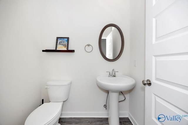 6032 Barringer Ct, Huntsville, AL 35806 - half bath with toilet, wood finished floors, a sink, and baseboards