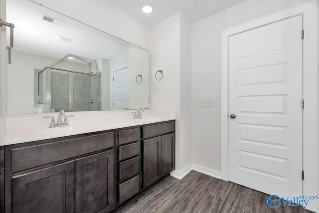 6032 Barringer Ct, Huntsville, AL 35806 - bathroom featuring a shower stall, wood finished floors, a sink, and visible vents