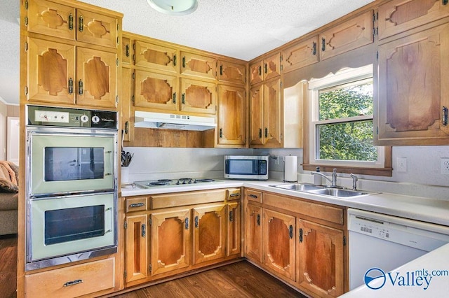 3392 Williams St, Hokes Bluff, AL 35903 - kitchen with white appliances, under cabinet range hood, light countertops, dark wood-style flooring, and a textured ceiling