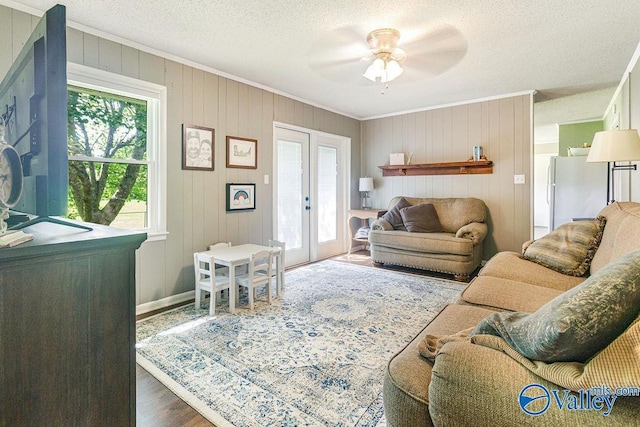 3392 Williams St, Hokes Bluff, AL 35903 - living room with ornamental molding, wood finished floors, a textured ceiling, a ceiling fan, and french doors