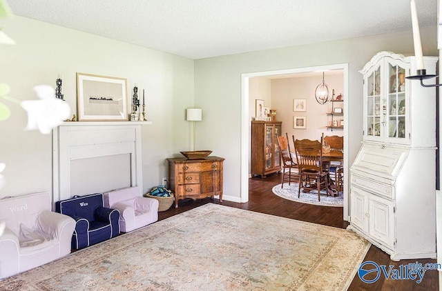 3392 Williams St, Hokes Bluff, AL 35903 - sitting room with dark wood-style flooring and a chandelier