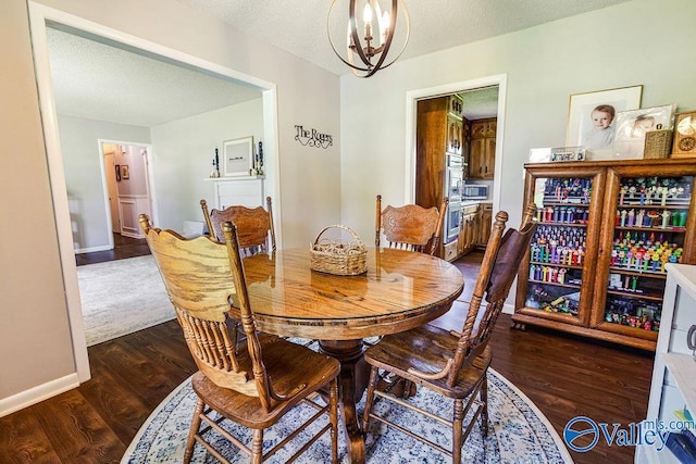 3392 Williams St, Hokes Bluff, AL 35903 - dining space with a chandelier, dark wood finished floors, and a textured ceiling