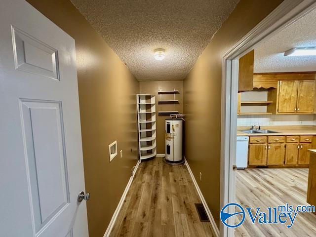 pantry featuring electric water heater and sink