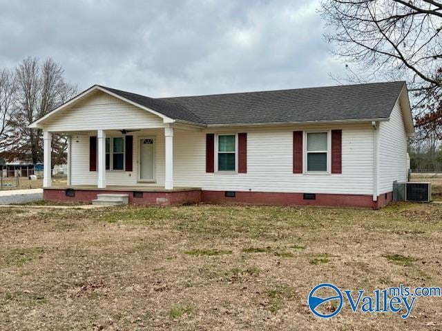 view of front of home with a front yard, central AC unit, and covered porch