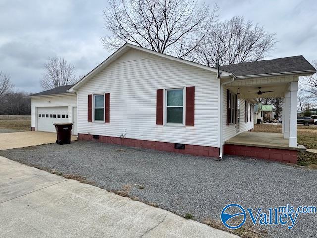 view of home's exterior with a garage, ceiling fan, and a porch