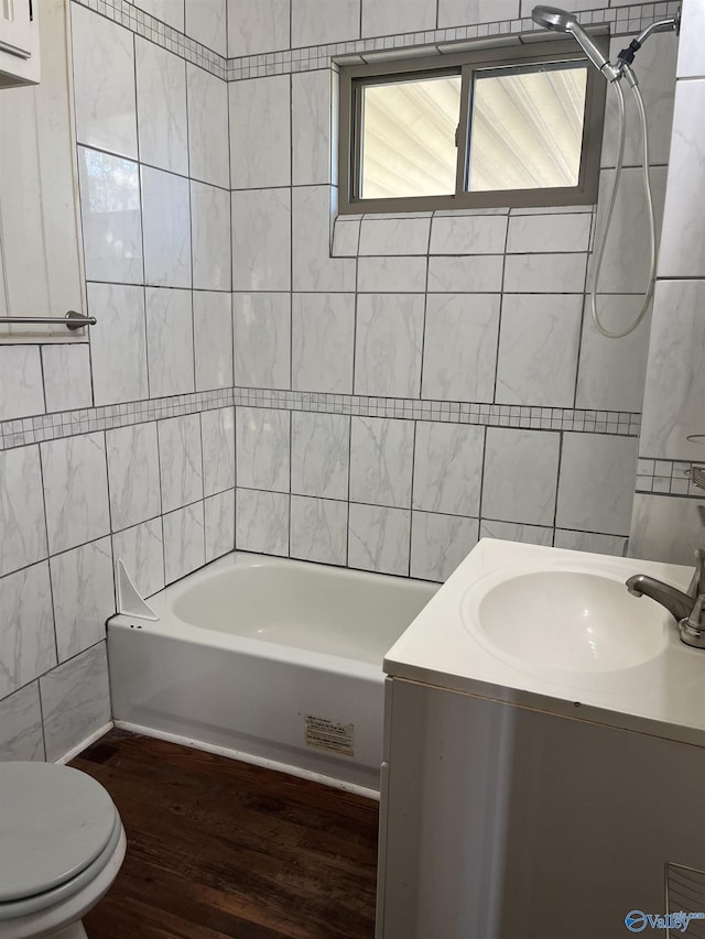 full bathroom featuring toilet, tile walls, vanity, and shower / tub combination