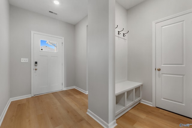 mudroom with baseboards, visible vents, and light wood-style floors