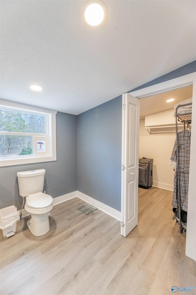 bathroom featuring hardwood / wood-style floors and toilet