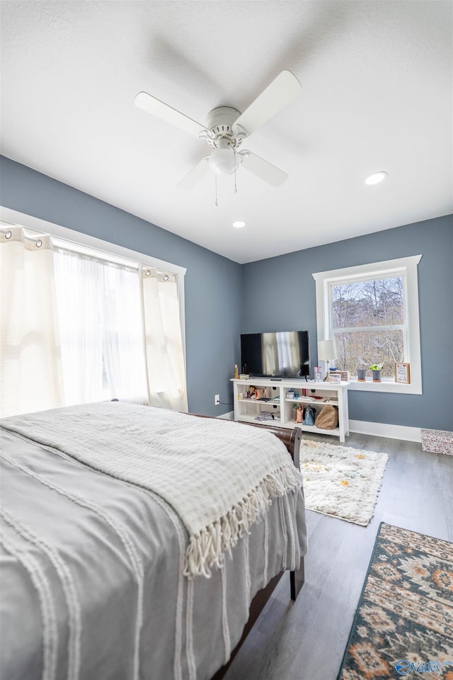 bedroom featuring ceiling fan and dark hardwood / wood-style floors