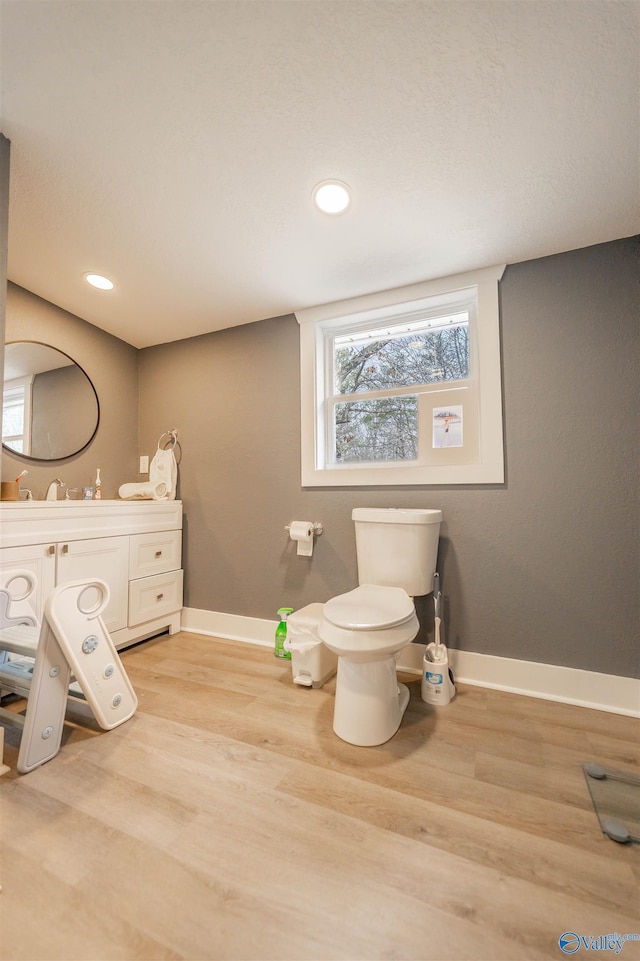 bathroom featuring vanity, toilet, and hardwood / wood-style floors