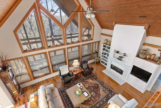 living room featuring hardwood / wood-style floors, a wealth of natural light, and ceiling fan