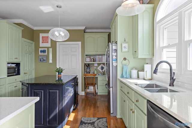 kitchen featuring dark wood-type flooring, sink, light stone counters, pendant lighting, and stainless steel appliances