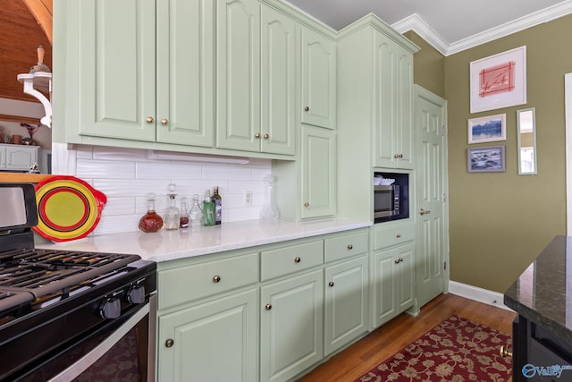 kitchen featuring crown molding, stainless steel appliances, tasteful backsplash, stone countertops, and dark hardwood / wood-style flooring