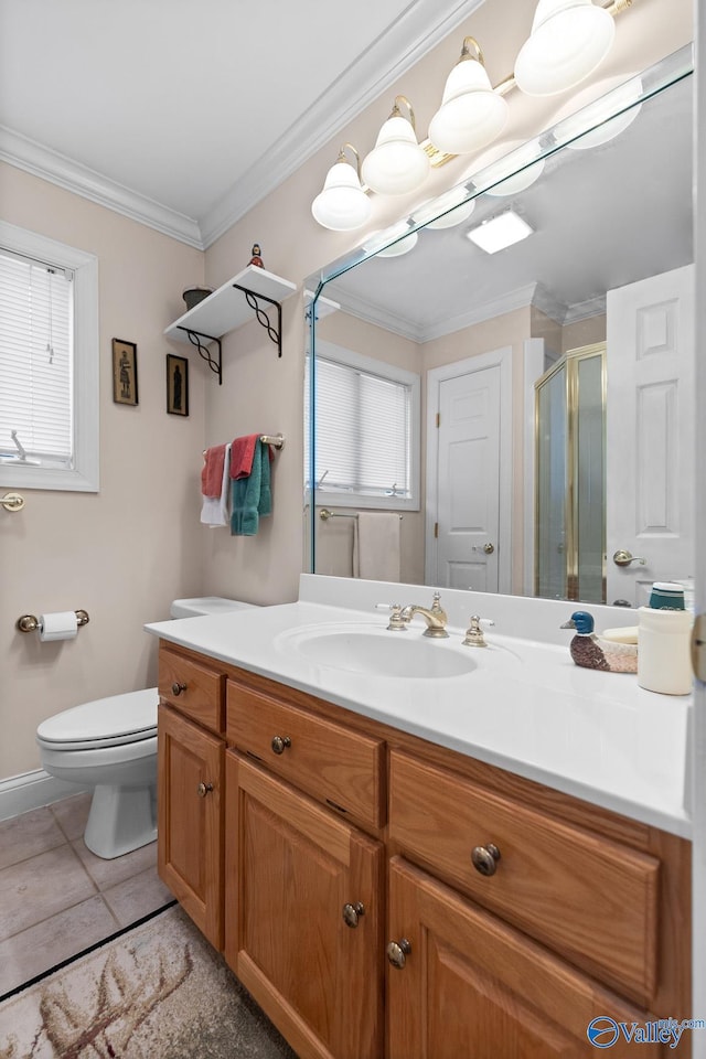 bathroom with vanity, ornamental molding, tile patterned floors, toilet, and walk in shower