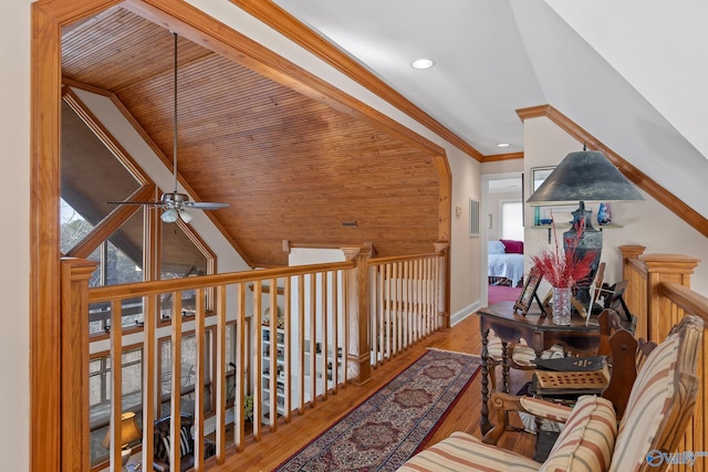 hall with wood-type flooring and ornamental molding