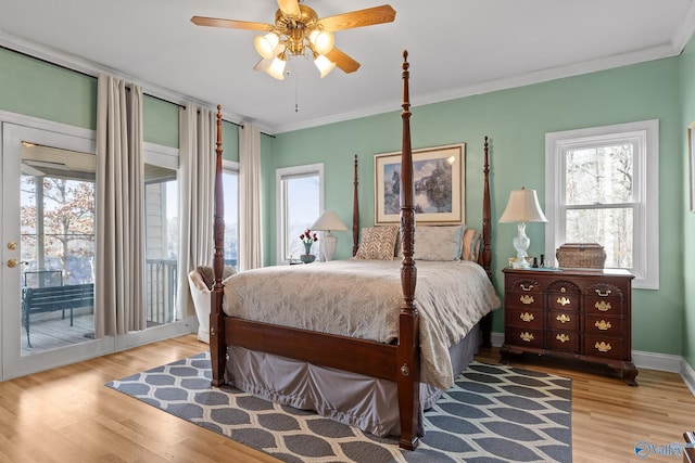 bedroom with ornamental molding, multiple windows, and access to outside