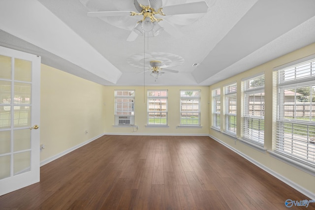 unfurnished sunroom with a raised ceiling, a wealth of natural light, and ceiling fan