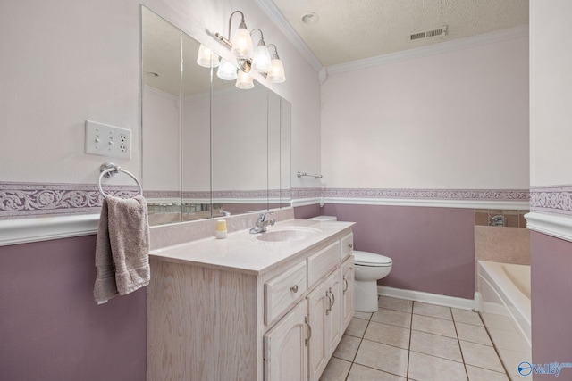 bathroom featuring a tub, vanity, ornamental molding, tile patterned floors, and a textured ceiling