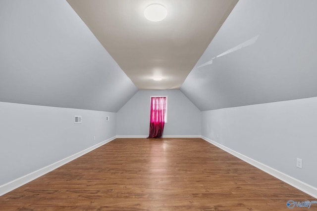 bonus room featuring lofted ceiling and hardwood / wood-style floors