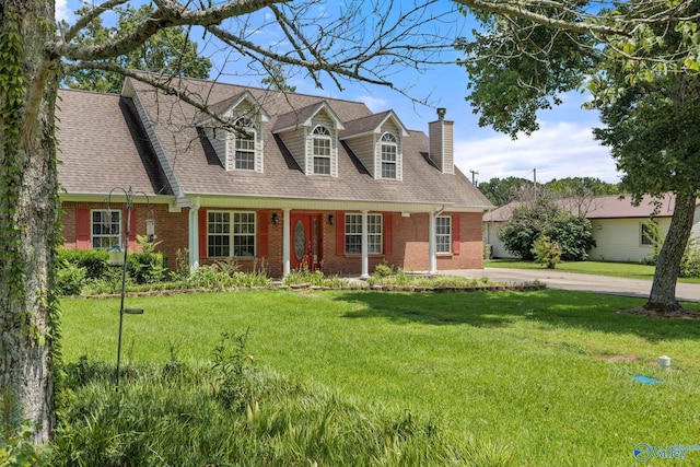 cape cod home with a front lawn