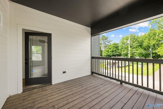 wooden deck featuring view of scattered trees