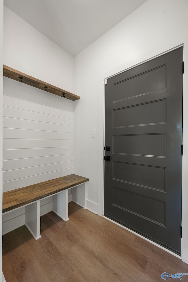 mudroom with wood finished floors and baseboards