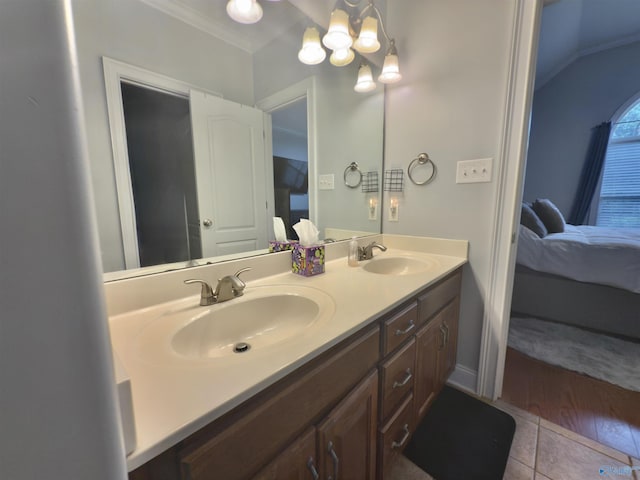 ensuite bathroom with tile patterned floors, a sink, and connected bathroom