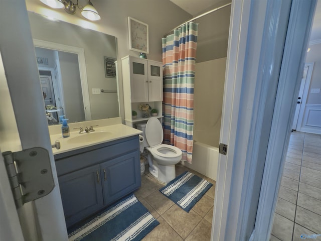 full bath with toilet, tile patterned flooring, shower / bath combo with shower curtain, and vanity