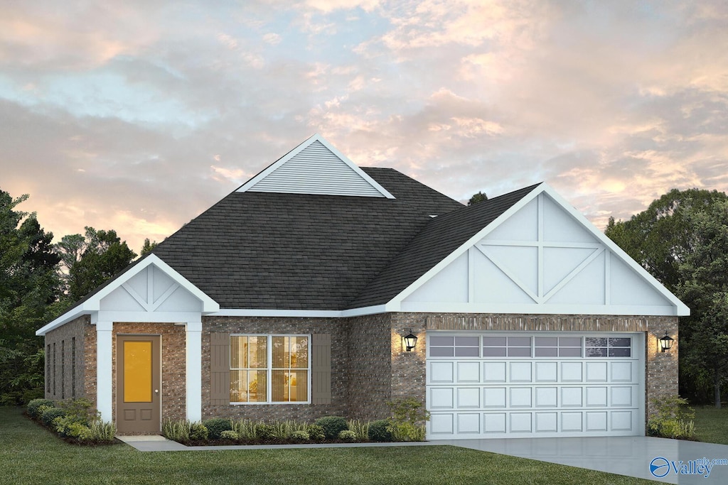 view of front of home featuring a yard and a garage