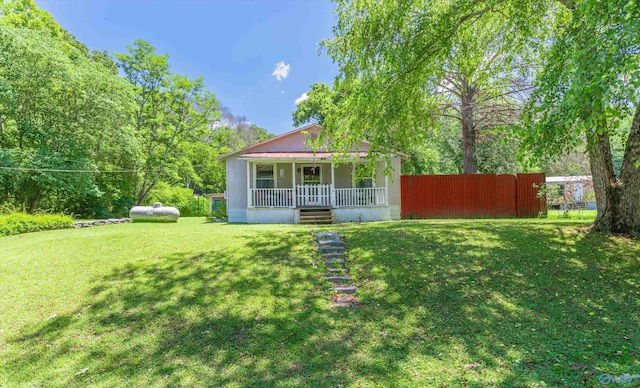 bungalow featuring a front yard, covered porch, and fence