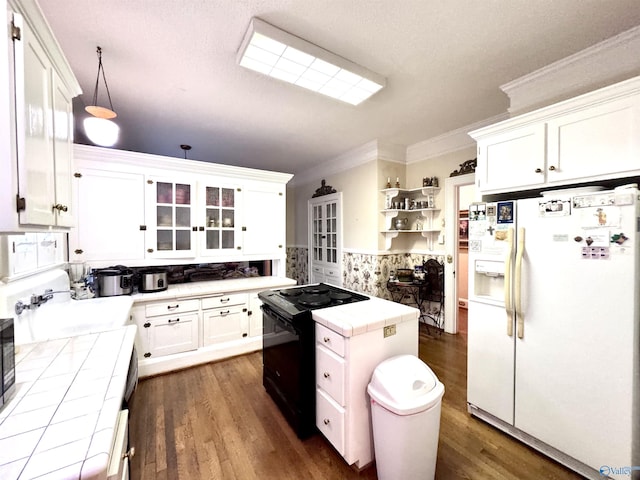 102 Jackson St, Albertville, AL 35950 - kitchen featuring white refrigerator with ice dispenser, tile countertops, electric range, open shelves, and ornamental molding