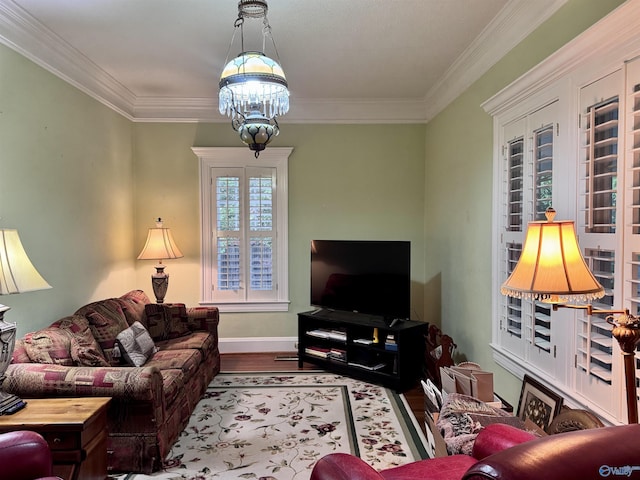 102 Jackson St, Albertville, AL 35950 - living room featuring wood finished floors, ornamental molding, baseboards, and a chandelier