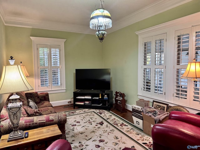 102 Jackson St, Albertville, AL 35950 - living room with wood finished floors, crown molding, baseboards, and a chandelier