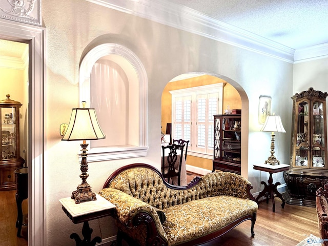 102 Jackson St, Albertville, AL 35950 - living area featuring arched walkways, wood finished floors, and ornamental molding