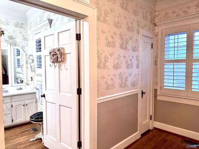 102 Jackson St, Albertville, AL 35950 - bathroom featuring wood finished floors, wallpapered walls, vanity, crown molding, and baseboards