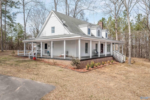 country-style home with covered porch, a chimney, and a shingled roof