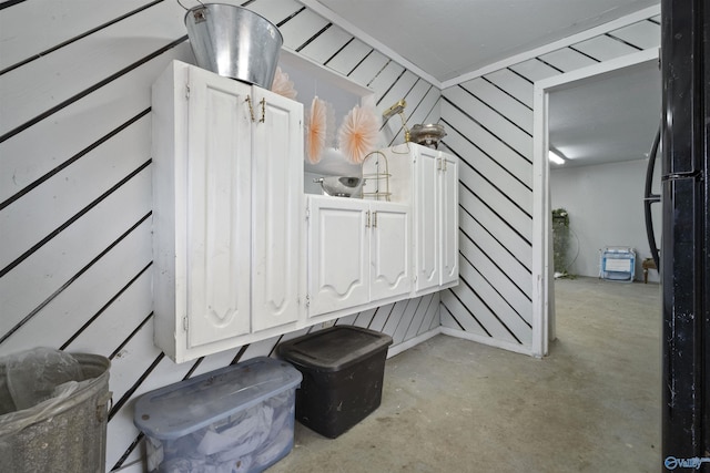 interior space featuring concrete flooring and wood walls