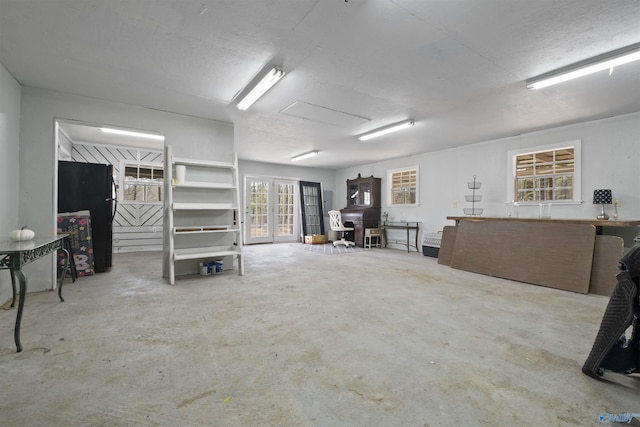 interior space featuring french doors and freestanding refrigerator